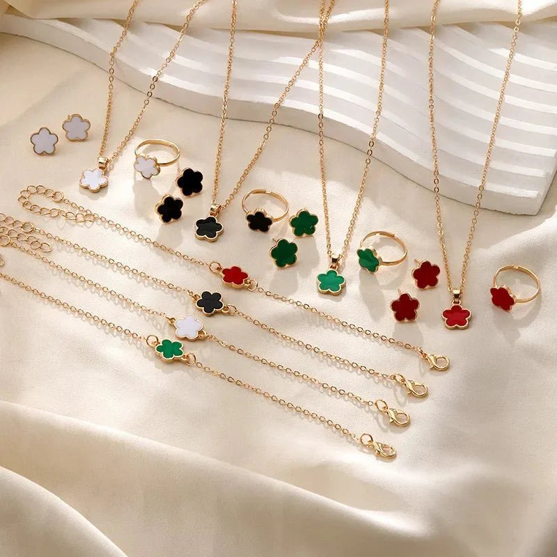 https://cdn.shopify.com/s/files/1/0820/4999/0943/files/dainty-lucky-floral-clover-necklace-bracelet-earrings-and-rings-set-215415.webp?v=1721505599