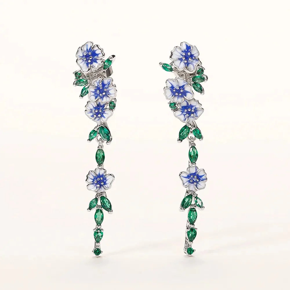 https://cdn.shopify.com/s/files/1/0820/4999/0943/files/glossy-blue-floral-dangling-earrings-999176.webp?v=1712446270