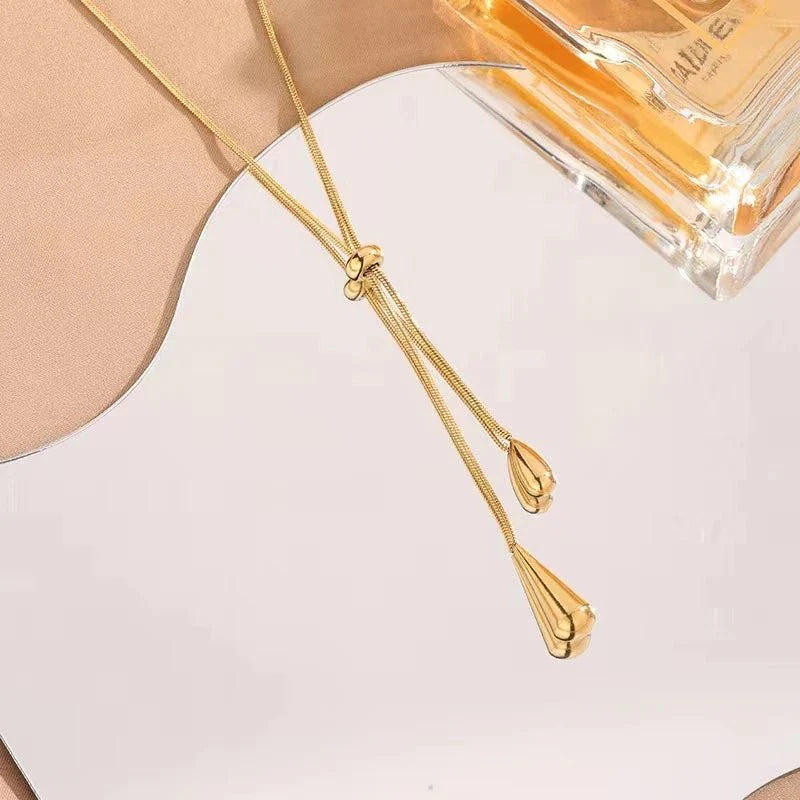 https://cdn.shopify.com/s/files/1/0820/4999/0943/files/adjustable-pull-droplet-lariat-necklace-and-earrings-600596.webp?v=1720179727