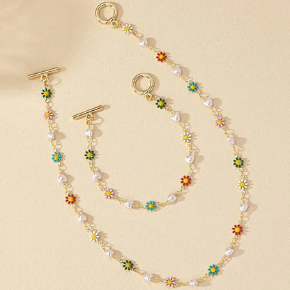 https://cdn.shopify.com/s/files/1/0820/4999/0943/files/dainty-spring-floral-pearls-bracelet-and-necklace-set-342821.webp?v=1715165103