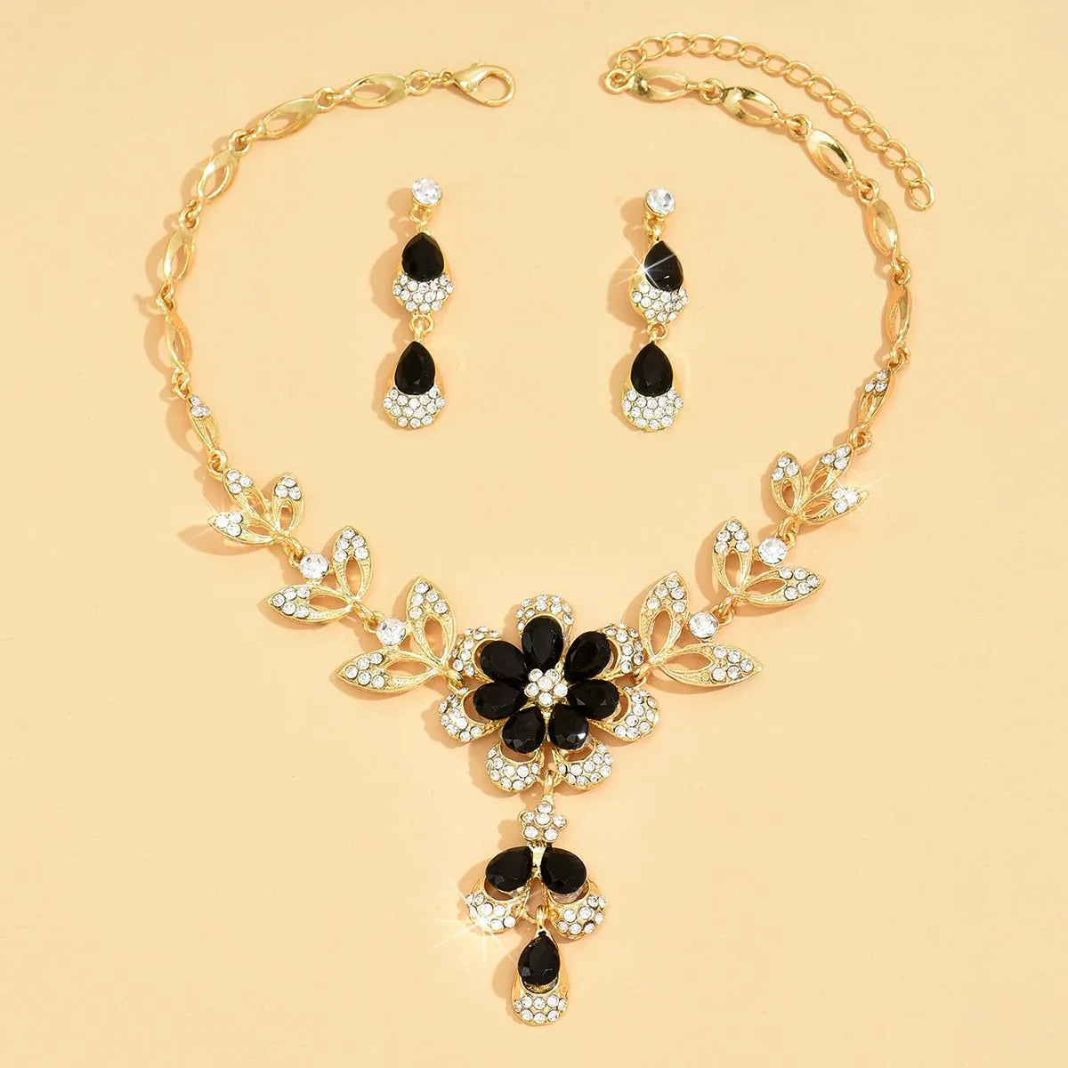 https://cdn.shopify.com/s/files/1/0820/4999/0943/files/floral-black-and-gold-diamond-necklace-and-earring-set-883240.webp?v=1718191087