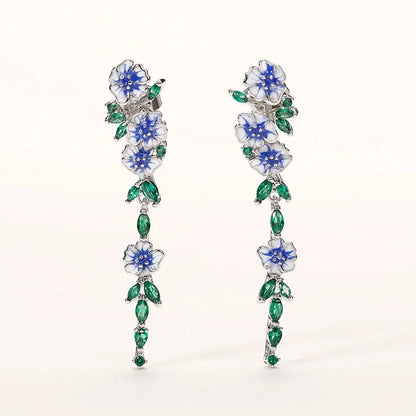 https://cdn.shopify.com/s/files/1/0820/4999/0943/files/glossy-blue-floral-dangling-earrings-999176.webp?v=1712446270