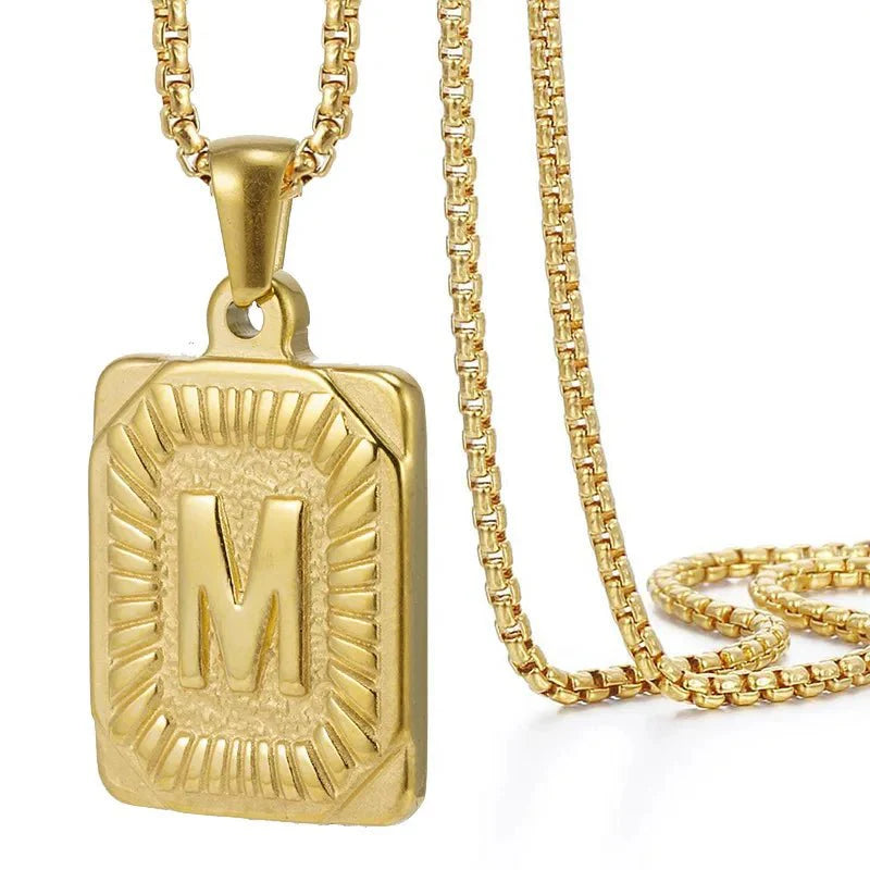 https://cdn.shopify.com/s/files/1/0820/4999/0943/files/textured-rectangle-letter-initial-necklace-240655.webp?v=1724157553