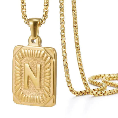https://cdn.shopify.com/s/files/1/0820/4999/0943/files/textured-rectangle-letter-initial-necklace-297542.webp?v=1724157553