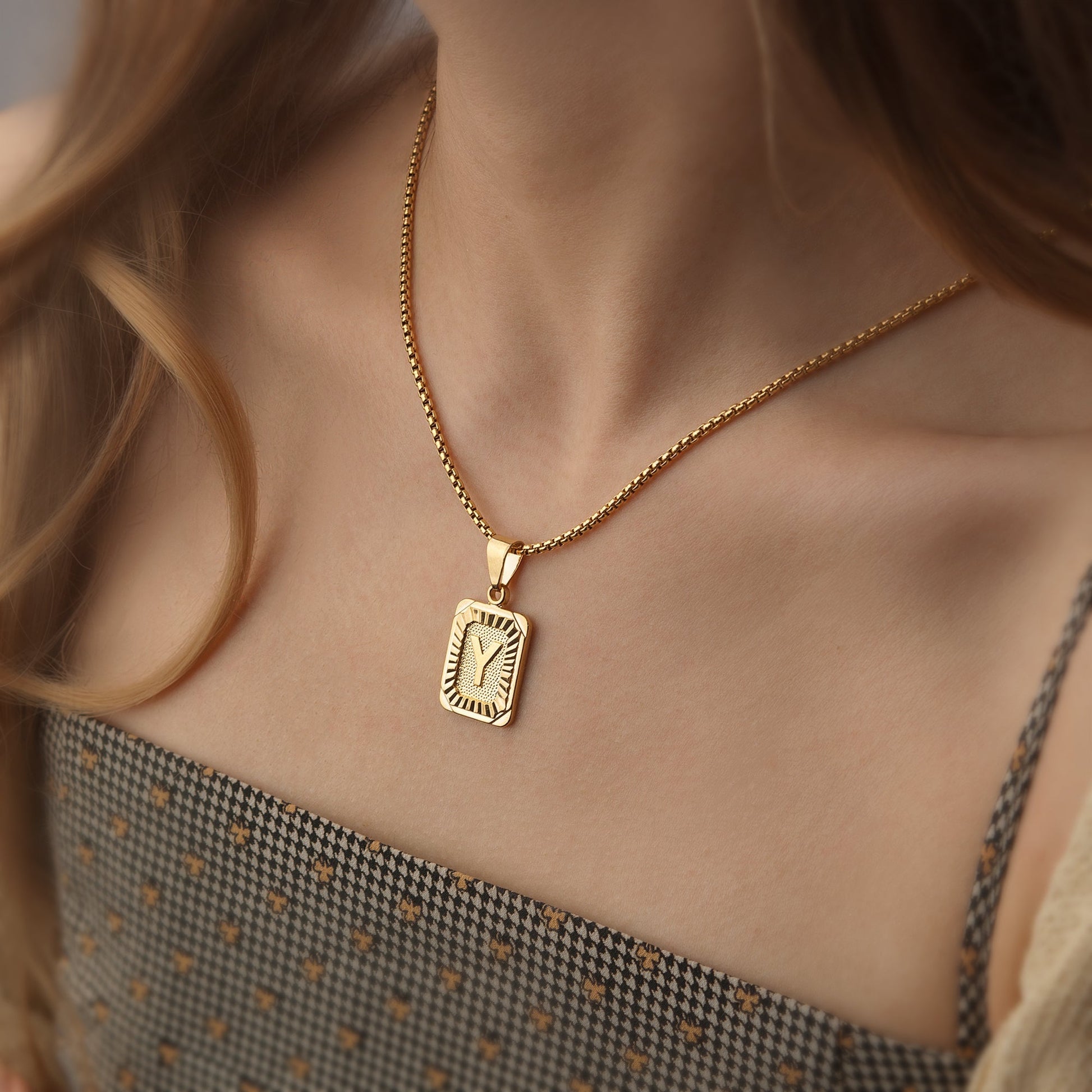 https://cdn.shopify.com/s/files/1/0820/4999/0943/files/textured-rectangle-letter-initial-necklace-388513.jpg?v=1762198552