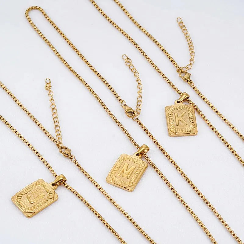 https://cdn.shopify.com/s/files/1/0820/4999/0943/files/textured-rectangle-letter-initial-necklace-521252.webp?v=1724157553