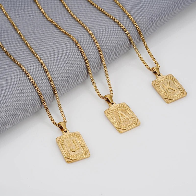 https://cdn.shopify.com/s/files/1/0820/4999/0943/files/textured-rectangle-letter-initial-necklace-630396.webp?v=1724157553