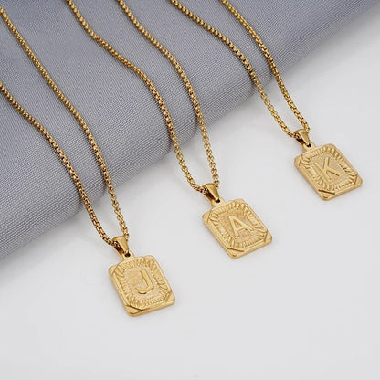 https://cdn.shopify.com/s/files/1/0820/4999/0943/files/textured-rectangle-letter-initial-necklace-630396.webp?v=1724157553