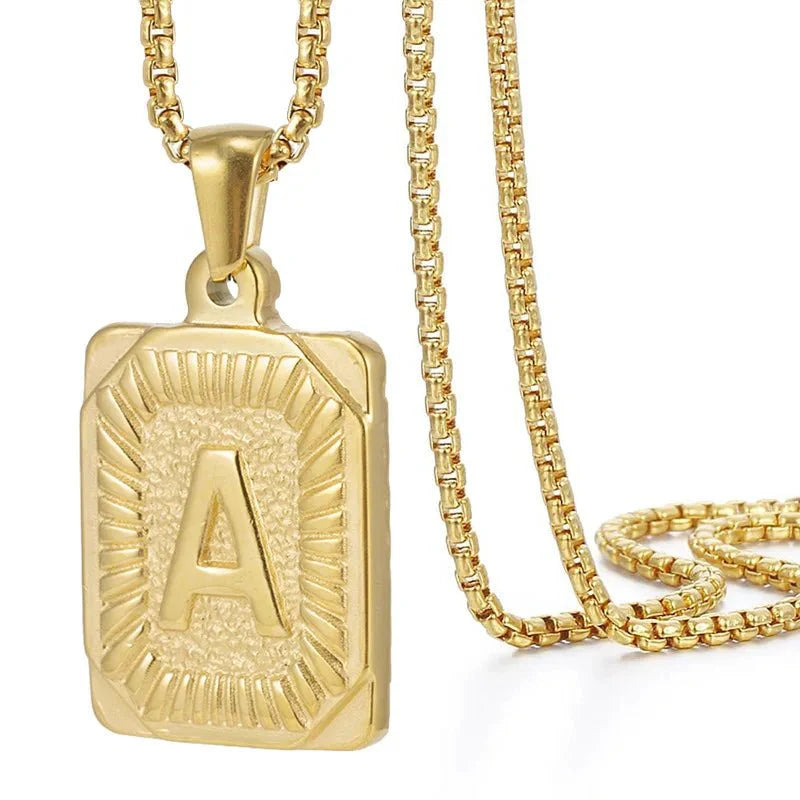 https://cdn.shopify.com/s/files/1/0820/4999/0943/files/textured-rectangle-letter-initial-necklace-704441.webp?v=1724157553