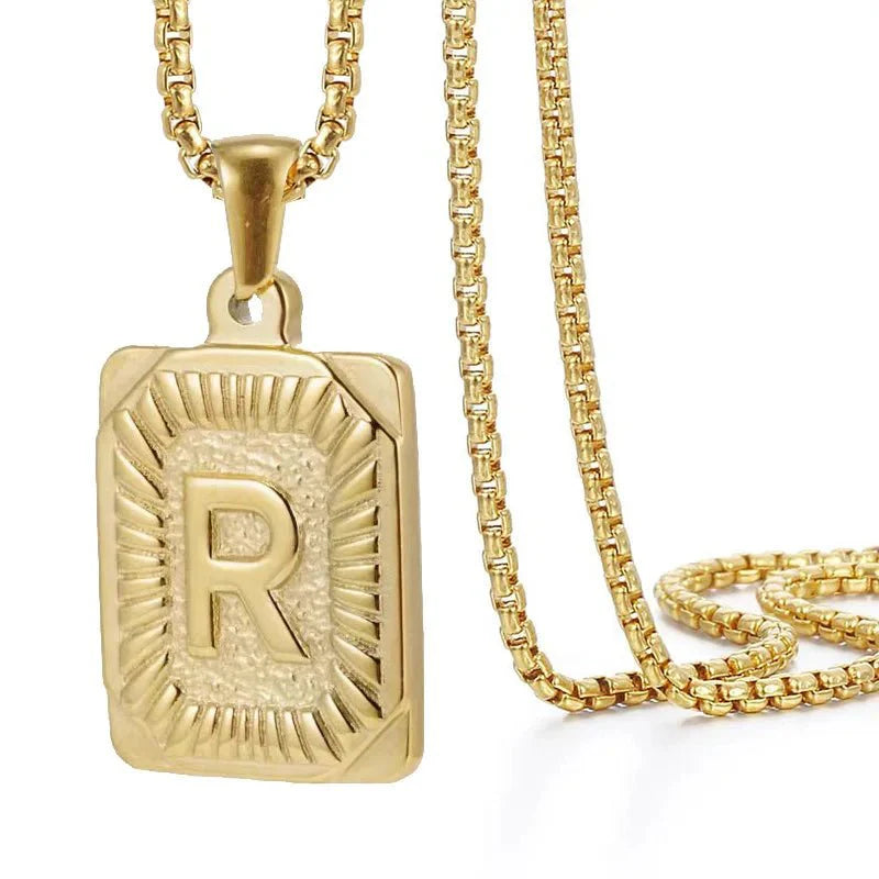 https://cdn.shopify.com/s/files/1/0820/4999/0943/files/textured-rectangle-letter-initial-necklace-856292.webp?v=1724157554